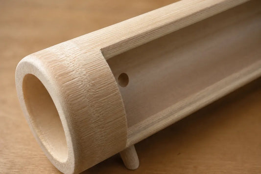 Close-up of phone slot and natural bamboo grain on Zen phone stand