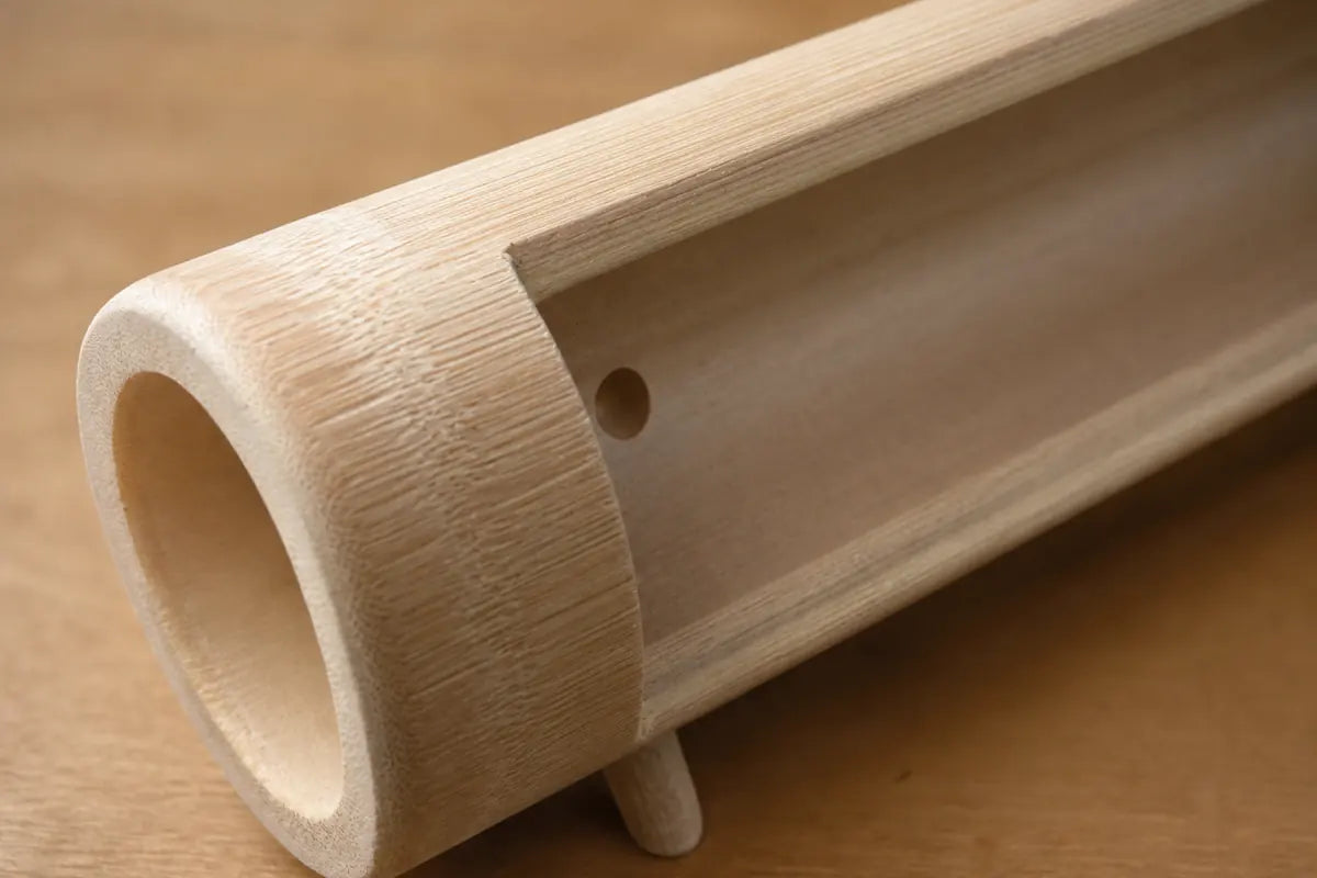Close-up of natural bamboo grain and phone slot on the Zen acoustic phone stand